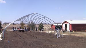 A hoophouse is constructed at Laura Krouse's Abbe Hills Farm  near Mount Vernon. The farm offers CSA shares throughout the growing season. (photo/Cindy Hadish)