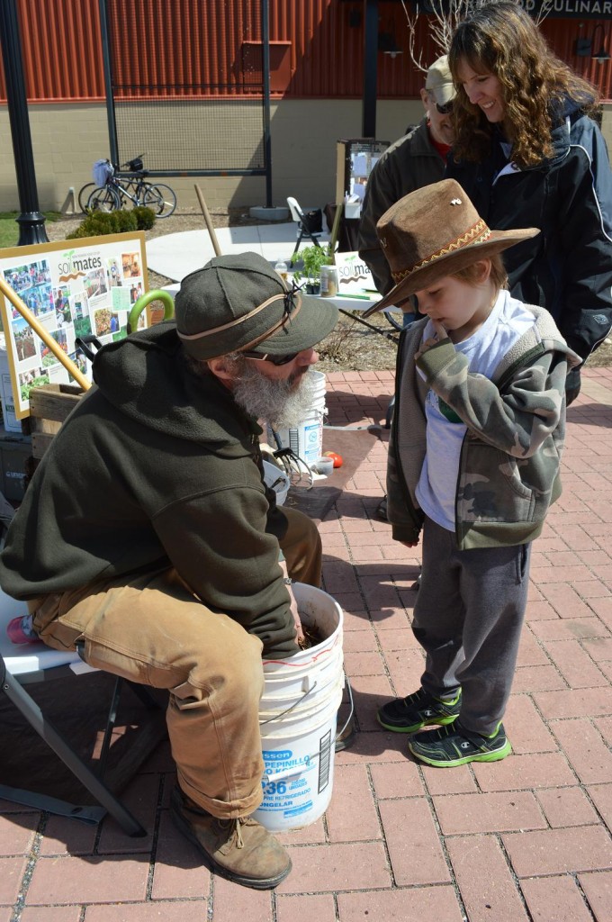 Scott Koepke of SoilMates teaches 6-year-old Ian about the benefits of composting during Eco-Fest 2013. (photo/Cindy Hadish)