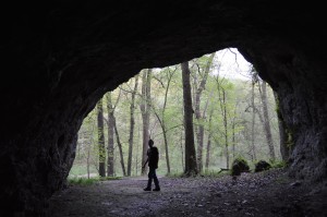 A visitor walks near the entrance of Horse Thief Cave at Wapsipinicon State Park near Anamosa. The cave is one of the notable natural features in the nearly 400-acre park. (photo/Cindy Hadish)