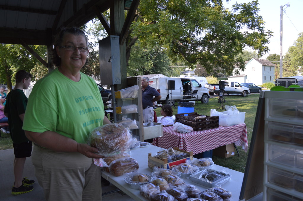 Market coordinator Kathy Tandy shows some of her baked goods during the Oxford Farmers Market on Monday, Aug. 5, 2013. (photo/Cindy Hadish)