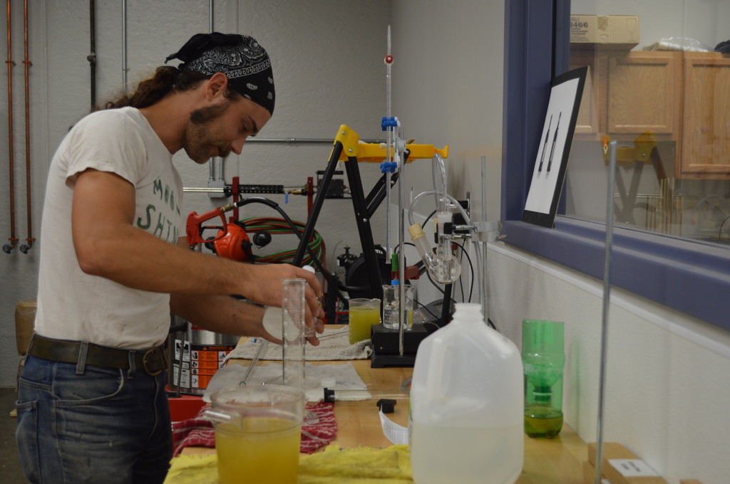 Viticulture instructor, Lucas McIntire, handles the chemistry portion of wine-making during class at Kirkwood Community College in Cedar Rapids. (photo/Cindy Hadish)