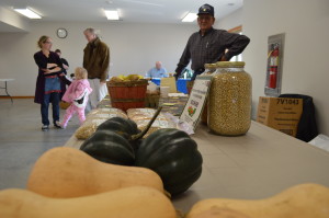 Marion Moser sells squash and other items on Saturday, Nov. 9, at the indoor Urbana Farmers Market. (photo/Cindy Hadish)