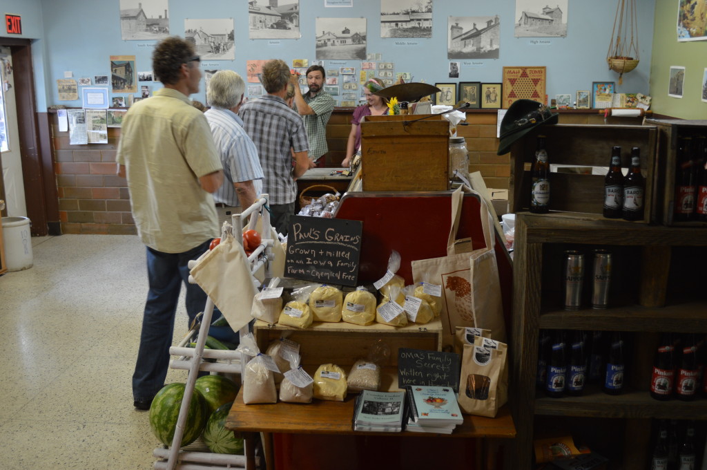 Customers line up to make their purchases inside Henry Village Market in Homestead, Iowa. An outdoor farmers market also operates at the site during  summer months. (photo/Cindy Hadish)