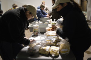 Producers bring their products for distribution day at the Iowa Valley Food Co-op in 2013. The "Come to the Table" summit, set for Feb. 7, brings together producers and local food buyers. (photo/Cindy Hadish)