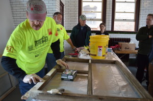 Participants learn window restoration techniques during the Cedar Rapids Historic Preservation Commission's Preservation Showcase last May in Cedar Rapids. A window restoration workshop is set for April 5, 2014, in Iowa City. (photo/Cindy Hadish) 