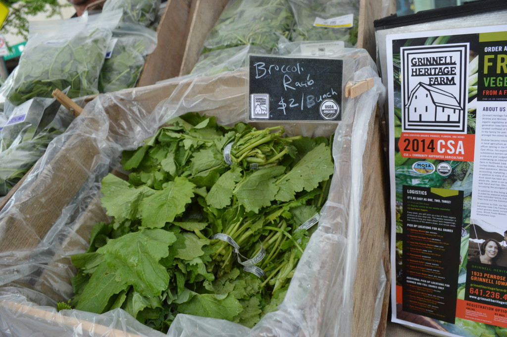 Fresh greens are sold by Grinnell Heritage Farm during the kick-off of the Downtown Farmers Market on Saturday, June 7, 2014. The farm is certified organic. (photo/Cindy Hadish)