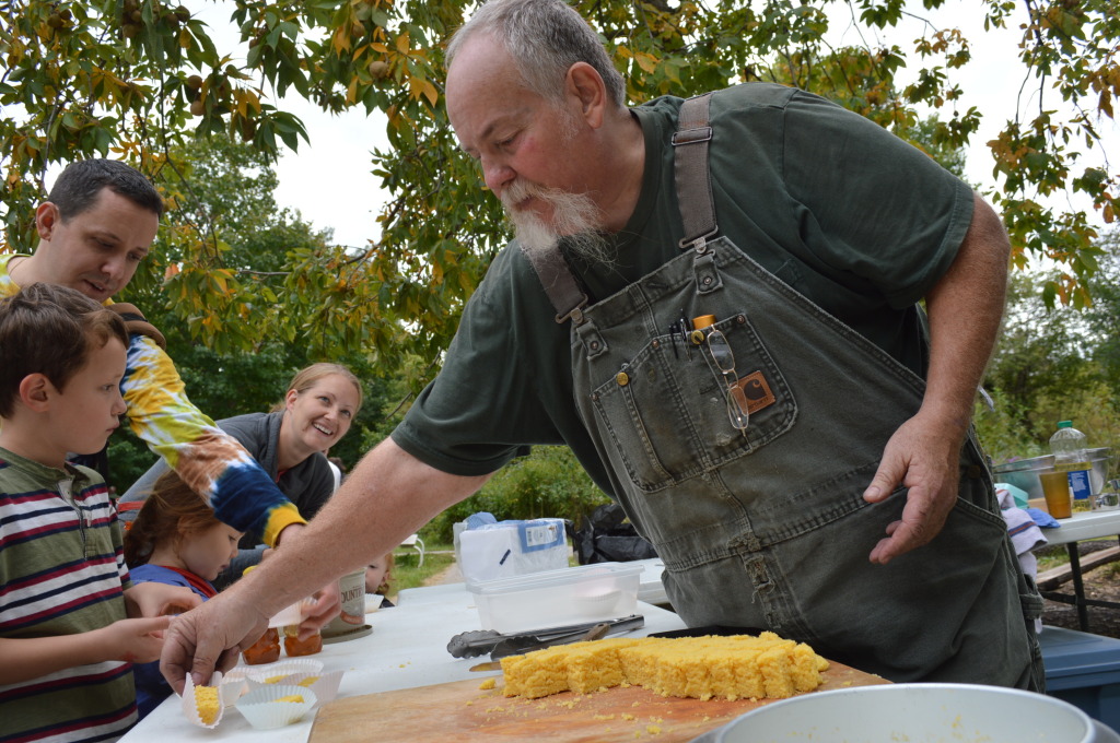 Honey from the Indian Creek Nature Center is offered on samples of cornbread baked by 20-year volunteer Mike Duss. (photo/Cindy Hadish)