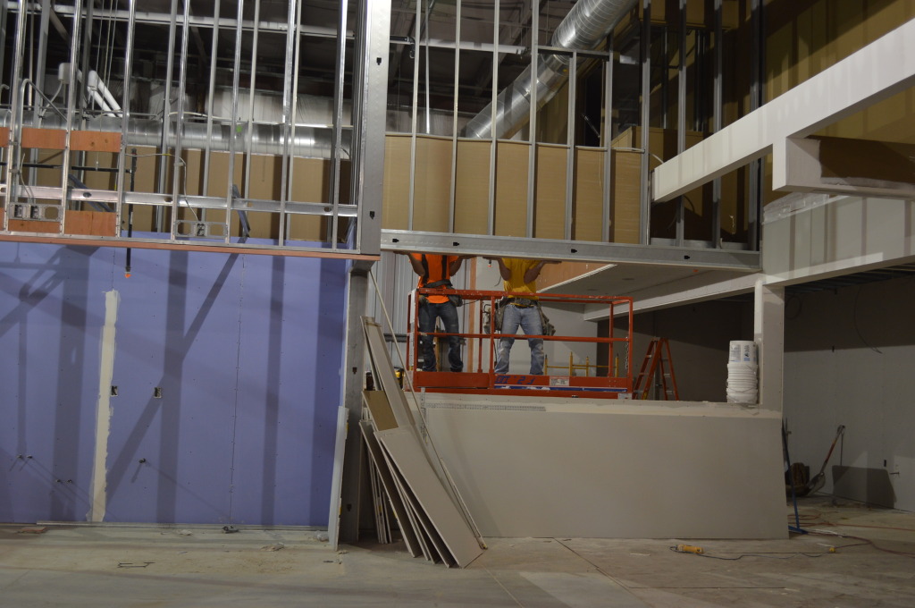 Workers install walls for the dine-in seating area of the prepared foods section at the New Pioneer Food Co-op store in Cedar Rapids. Matt Steigerwald, well-known in local foods circles, will lead the prepared food team at the new store. (photo/Cindy Hadish) 