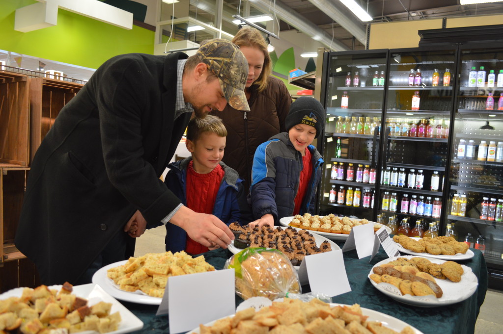 Customers sample baked goods during a "sneak peek" of New Pioneer Food Co-op's Cedar Rapids store in December 2014. The store will celebrate its another grand opening in March. (photo/Cindy Hadish)