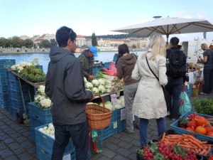 Customers shop at a farmers market along the Vltava River in Prague, Czech Republic. The Czech legend of the Three Kings serves as a warning for a late frost. (photo/Cindy Hadish)