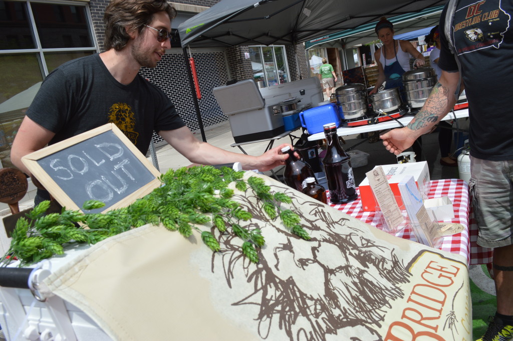 Business was brisk at the Lion Bridge Brewery booth at the Downtown Farmers Market in Cedar Rapids. Lion Bridge is located in Czech Village. (photo/Cindy Hadish)