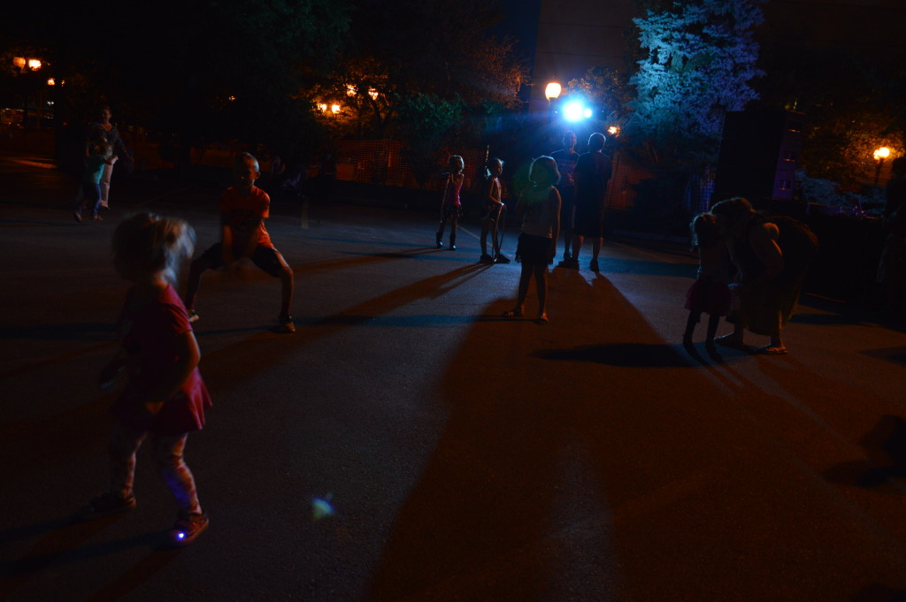 Children dance on the sidewalk on Saturday, Aug. 29, 2015, during the first Market After Dark in Cedar Rapids, Iowa. (photo/Cindy Hadish)