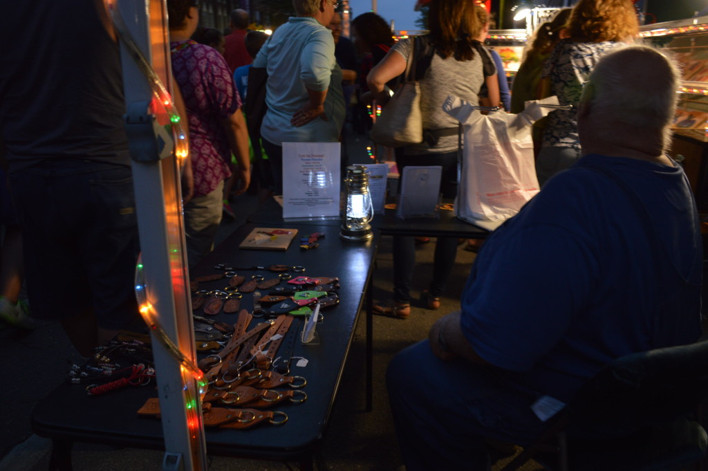 Festival lighting shines on Larry and Helen Kubalek's Wood Visions stand at Market After Dark. (photo/Cindy Hadish)