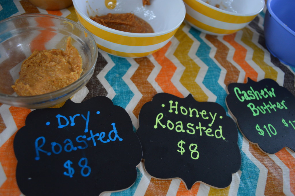 Samples of nut butters are offered for tasting at the Uptown Marion Farmers Market. (photo/Cindy Hadish)