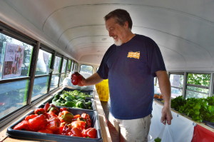 Navy veteran Allan Pike chooses a red pepper inside the Feed Iowa First bus during the Five Seasons Stand Down at Veterans Memorial Stadium. (photo/Cindy Hadish)