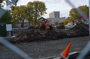 Construction equipment can be seen through a fence surrounding Greene Square Park in downtown Cedar Rapids, which is undergoing a major renovation. (photo/Cindy Hadish)
