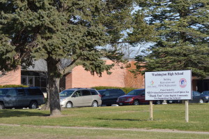 A sign outside of Washington High School notes the project that took place inside the school. The school was closed this summer over concerns related to asbestos removal. (photo/Cindy Hadish)