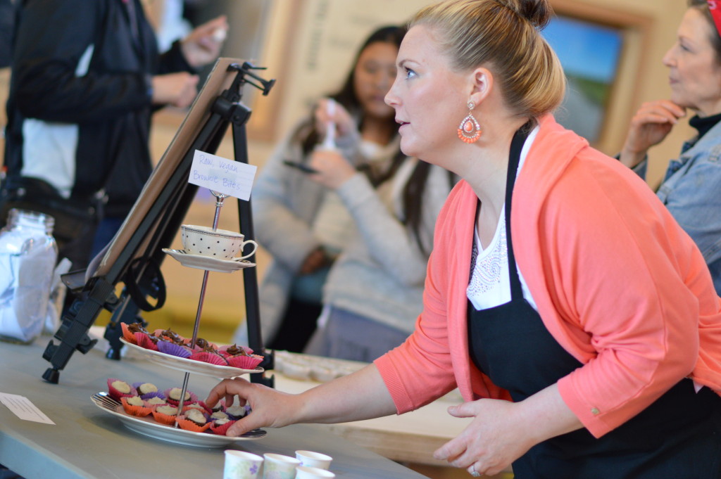 Jessica LaFayette adds brownie bites to a tray while talking to customers at the Rawlicious preview tasting at the NewBo City Market in Cedar Rapids, Iowa. (photo/Cindy Hadish)