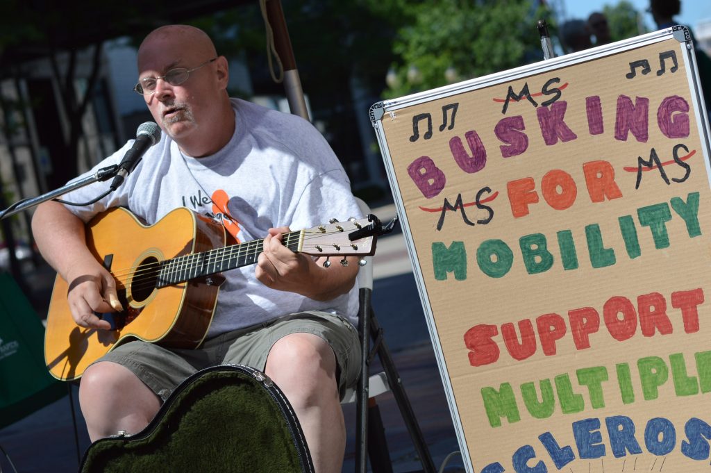 Singer Mark Brown performs during the Downtown Farmers Market as Busking for Mobility to raise money to support the Multiple Sclerosis Society. (photo/Cindy Hadish) 