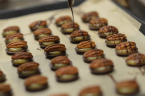 Chocolate is drizzled on Baby Sea Turtles, a Sweet Raw Joy creation sold at New Pioneer Food Co-op. (photo/Cindy Hadish)
