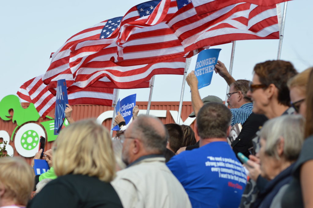 The crowd cheers as Hillary Clinton speaks Friday, Oct. 28, 2016, outside the NewBo City Market in Cedar Rapids, Iowa. (photo/Cindy Hadish)