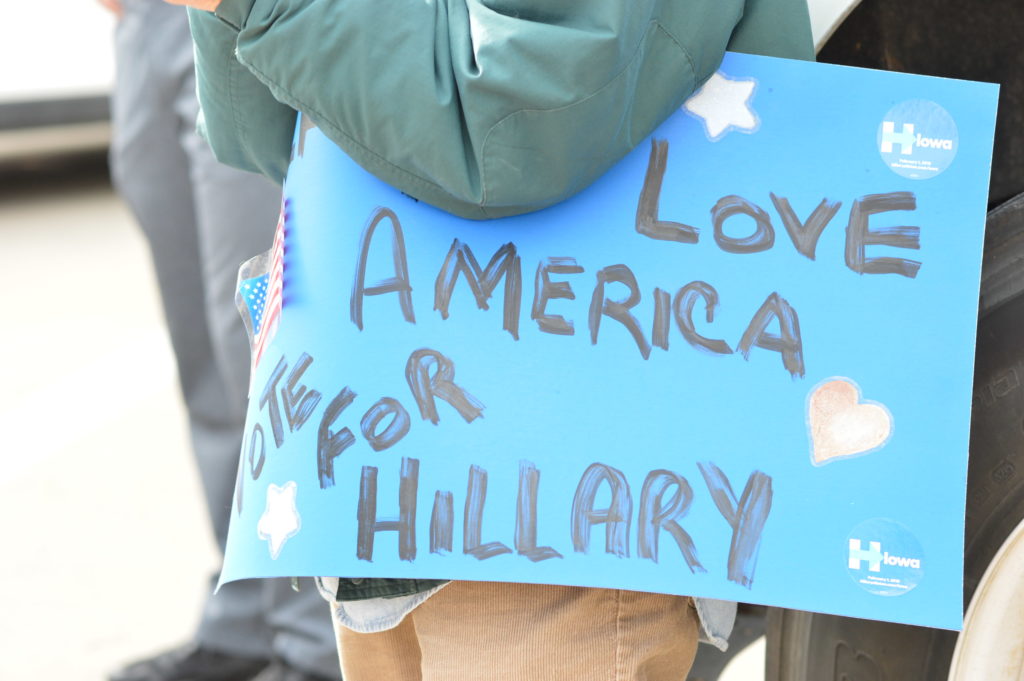A supporter holds a sign for Hillary Clinton outside the NewBo City Market. (photo/Cindy Hadish)