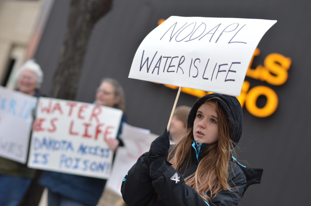 Makynzie Doyle, 12, joins other demonstrators in a protest against the Dakota Access pipeline outside of Wells Fargo in downtown Cedar Rapids on Dec. 1, 2016. (photo/Cindy Hadish)